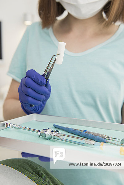 Dental assistant holding tray of tools at the dental clinic  Munich  Bavaria  Germany
