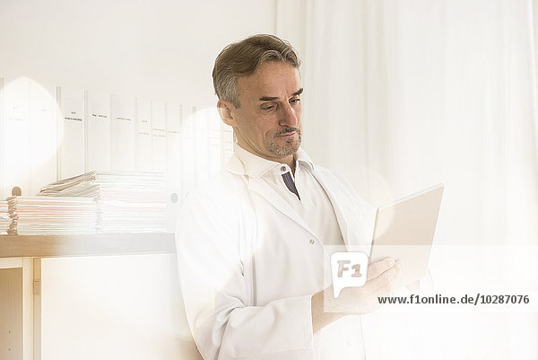 Male doctor using digital tablet in clinic  Munich  Bavaria  Germany