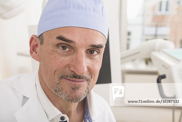 Portrait of dentist wearing surgical cap  Munich  Bavaria  Germany