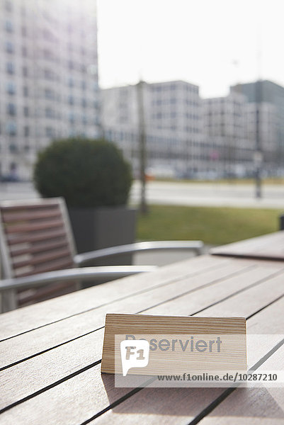 Reserved sign on the table in a sidewalk cafe Munich Bavaria Germany