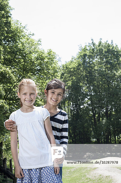 Portrait of two girls standing in playground  Munich  Bavaria  Germany