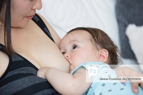 Close up of mature mother breastfeeding baby son
