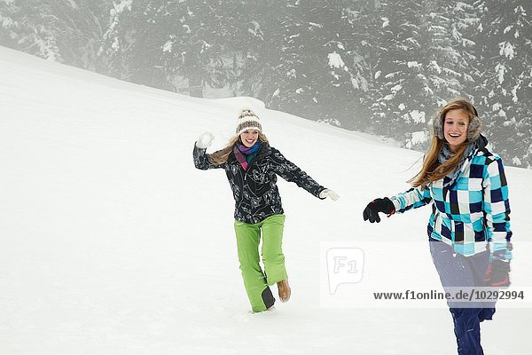 Young women playing in snow  Sattelbergalm  Tirol  Austria