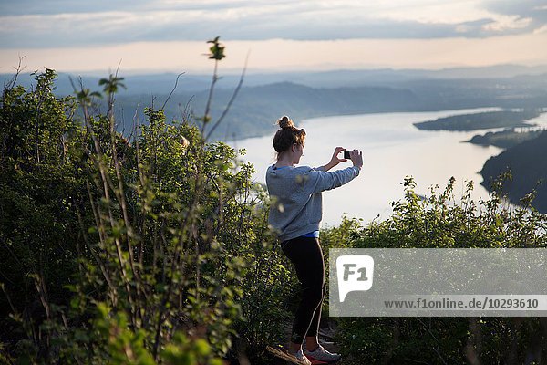 Woman taking photograph of view  Angel's Rest  Columbia River Gorge  Oregon  USA