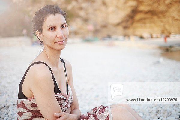 Mature woman sitting on beach  Javea  Spain