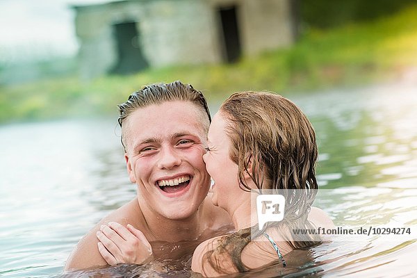 Young couple laughing in Secret Lagoon hot spring (Gamla Laugin)  Fludir  Iceland