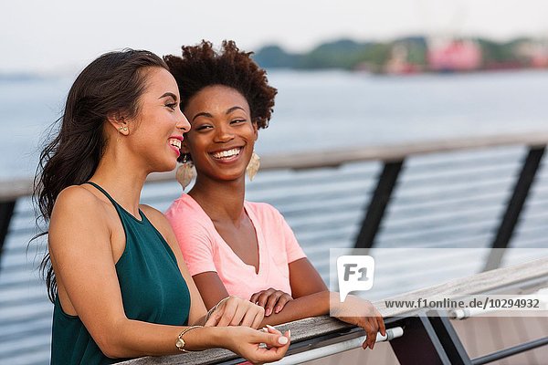 Young women chatting on bridge