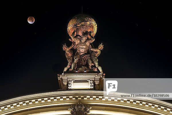 Sculpture of Atlas carrying globe  central station gateway  lunar eclipse  Frankfurt am Main  Hesse  Germany  Europe