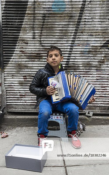 A boy playing the accordion on the road Istanbul Turkey Asia