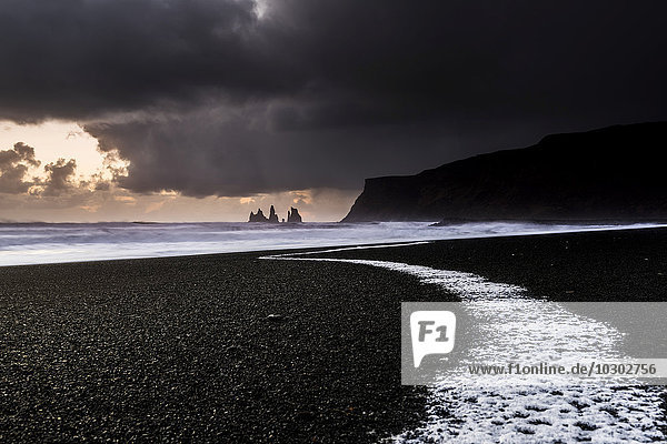 Beach  Reynisdrangar at sunset with ocean surf  black sand  near Vik  Southern Region  Iceland  Europe