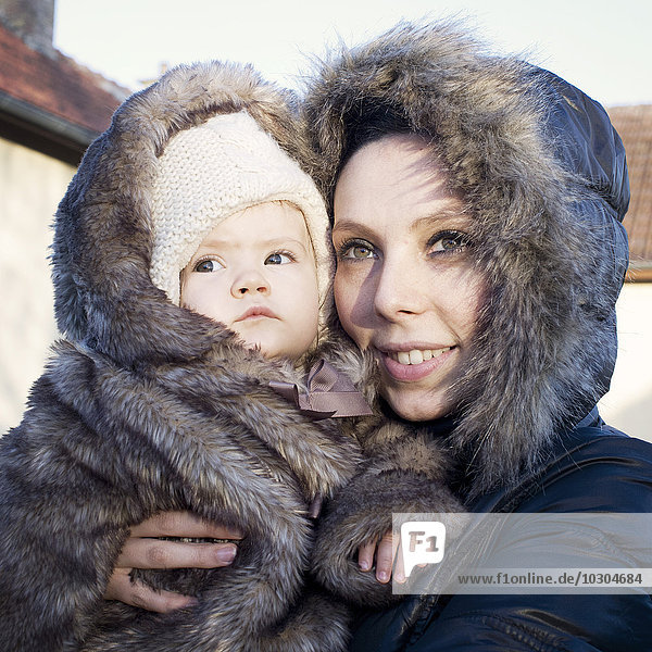 Mother and baby dressed in winter coats  portrait