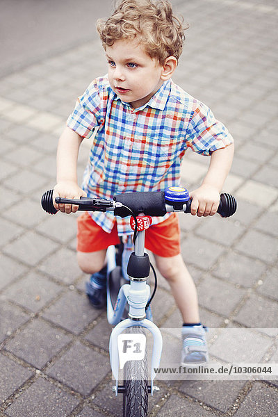 Portrait of little boy with scooter