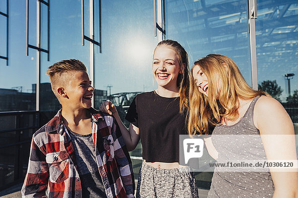 Three laughing teenagers outdoors