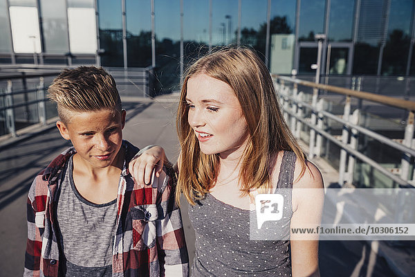 Two teenagers on pedestrian bridge