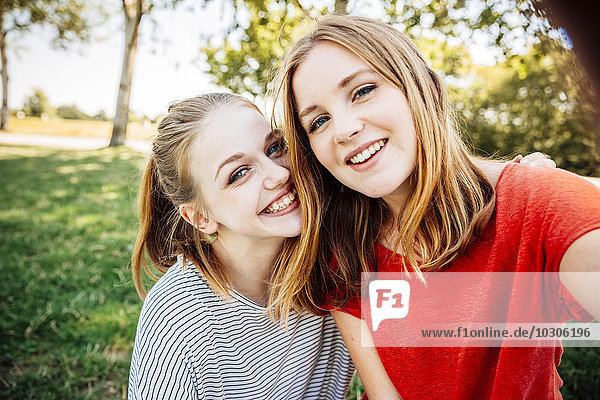 Two happy teenage girls taking a selfie
