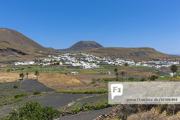Spain  Canary Islands  Lanzarote  Maguez  Village Haria and Volcano Monte Corona in the background