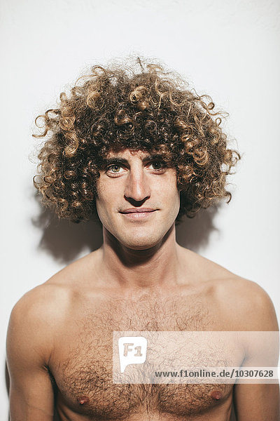 Portrait of naked man with curly hair