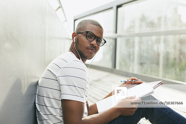 Young Afro-american man studying language