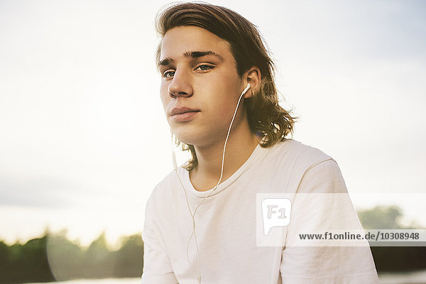 Portrait of young man with earbuds