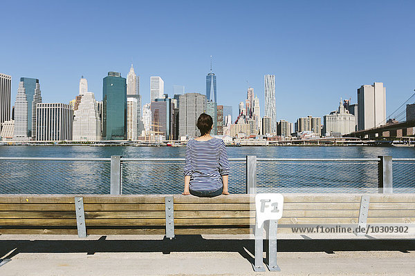 USA  New York City  back view of young woman looking at skyline