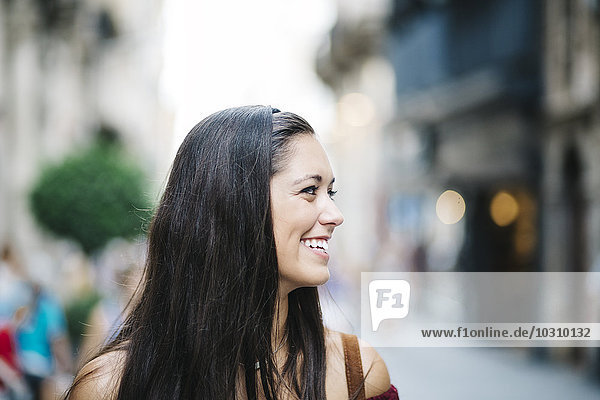Smiling young woman in the city
