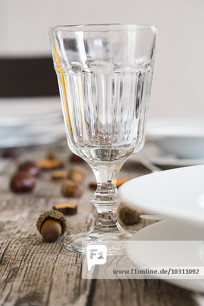 Crystal wine glass on autumnal laid table