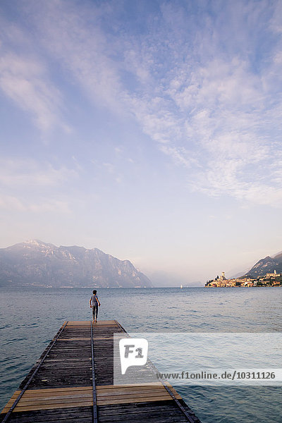 Italy  Veneto  Malcesine  Boy standing on jetty