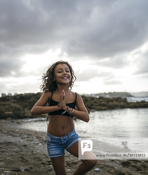 Spain  Gijon  portrait of smiling little girl on a beach