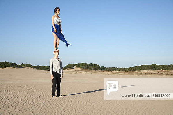 Netherlands  Woman standing on acrobats head