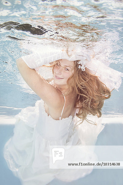 Junge Frau unter Wasser  Hochzeitskleid