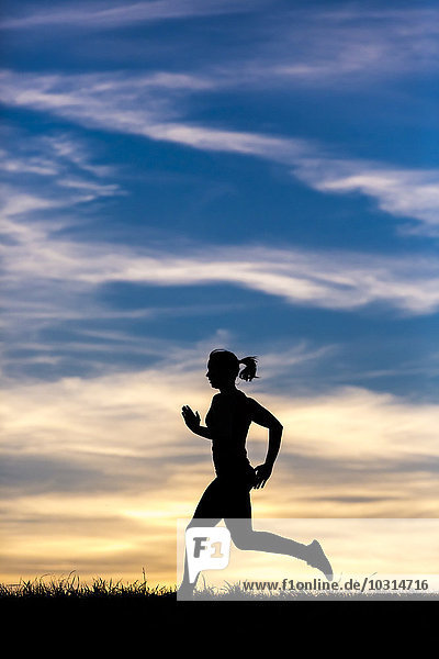 Silhouette of jogger at sunset