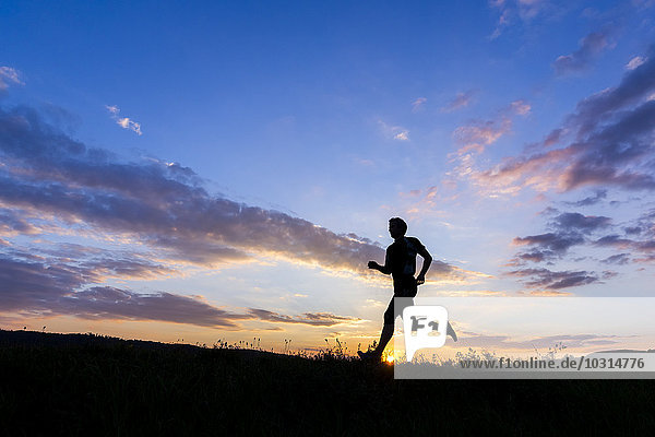 Man jogging at sunset