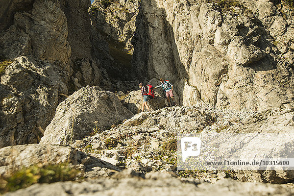 Austria  Tyrol  Tannheimer Tal  young couple hiking at rocks