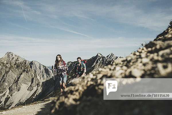 Österreich  Tirol  Tannheimer Tal  junges Paar beim Felsenwandern