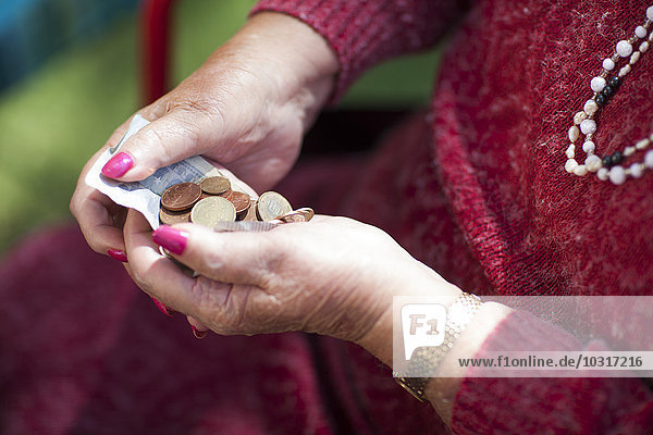 Money in senior woman's hands