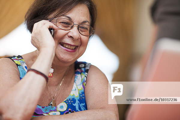 Smiling senior woman on cell phone
