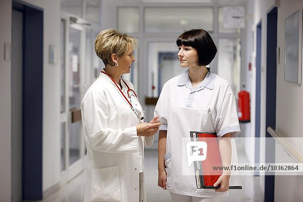 Female Doctor in a hospital. Talking to a nurse