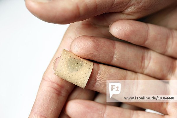 Bandaid is found onto a small wound at the finger