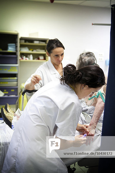 Reportage in the A&E department of Robert Ballanger general hospital  France. A nurse takes a blood sample in the trauma centre.