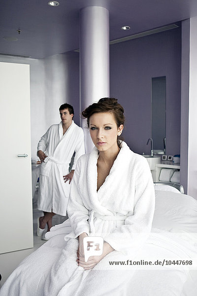 young man and young woman in bathrobe at spa