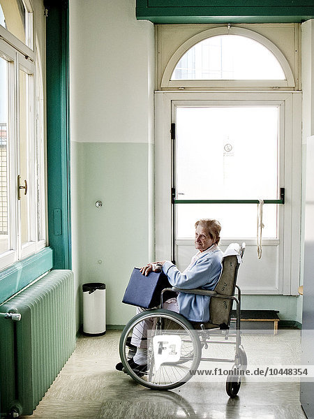 old lady sitting on a wheelchair in a hospital Hospital  Milan  Italy