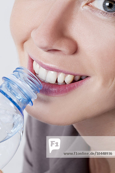 smiling woman while drinking water