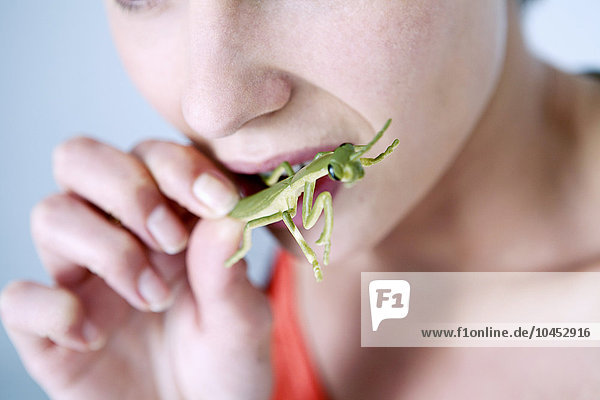 WOMAN EATING INSECT