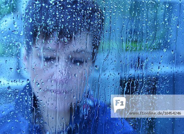 Woman  close-up portrait with water drops (blue tone)