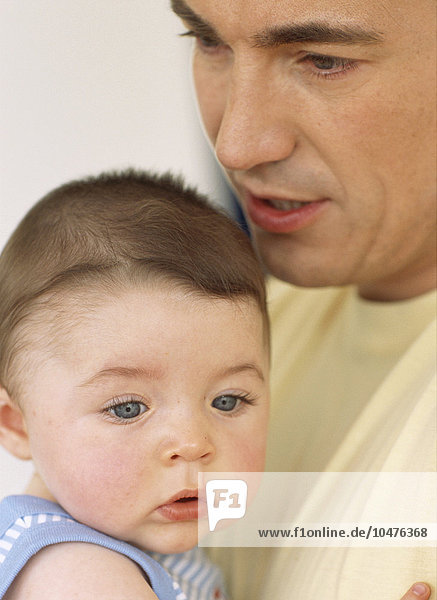 MODELL FREIGEGEBEN. Kleiner Junge und Vater. Gesichter eines 6 Monate alten Babyjungen und seines Vaters Babyjunge und Vater