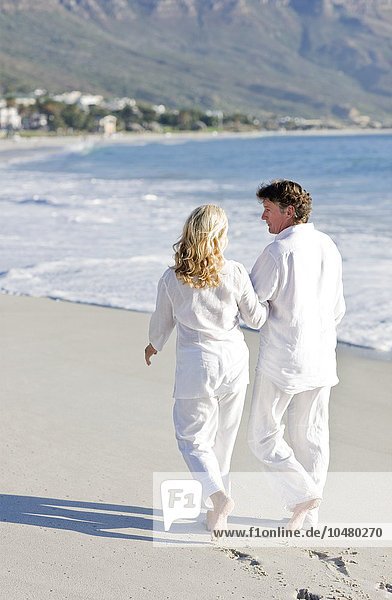 Couple walking along a beach