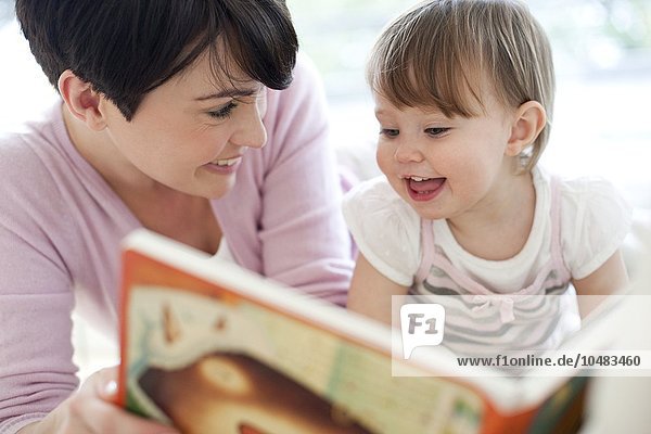 MODELL FREIGEGEBEN. Mutter und Tochter. Mutter liest ihrer 15 Monate alten Tochter vor Mutter und Tochter lesen