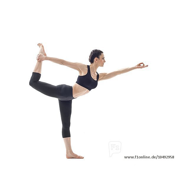MODEL RELEASED. Woman practicing yoga. This is dancer's pose. Woman practicing yoga