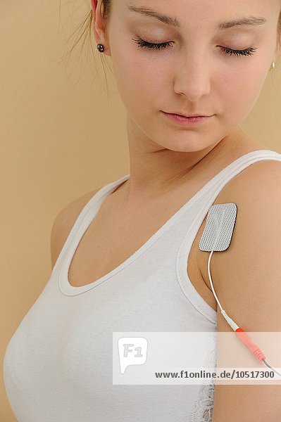 Electrodes in pads attached to a woman  transcutaneous electronic nerve stimulation