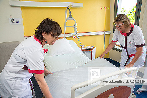 Reportage in the St Grgoire Hospital group in Rennes  France. Nursing auxiliaries preparing a bed.